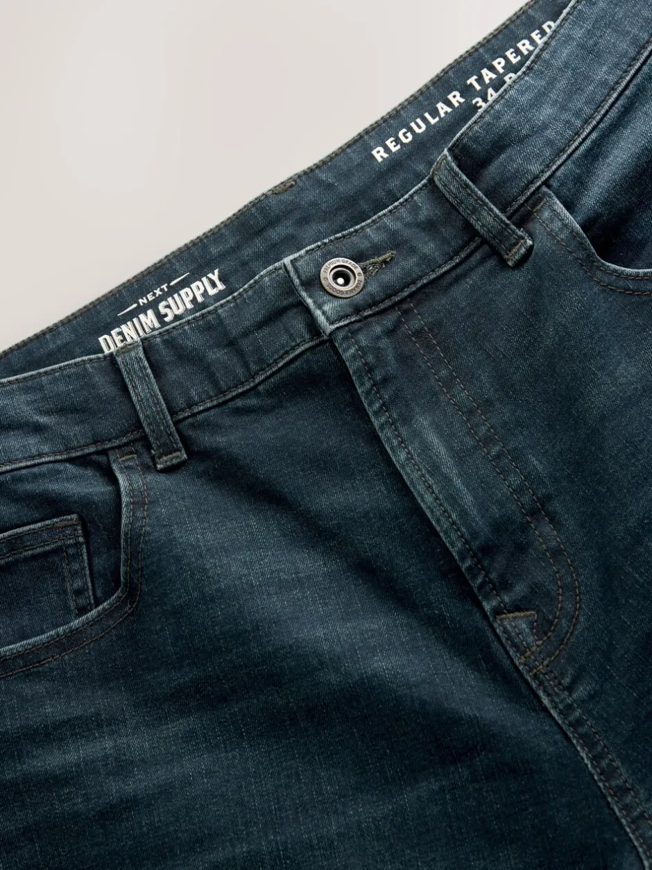 Jeans|Next Donkerblauwe wassing - Klassieke stretchjeans met standaard taps toelopende pasvorm