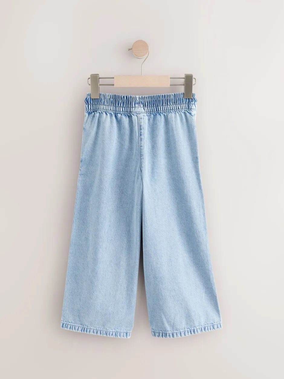 Jeans|Next - Jeans met elastische taille en wijde pijpen (3-16jr) Middenblauw denim