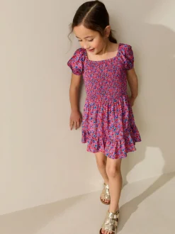 Jumpsuits En Playsuits*Next Roze met vrolijke print - Romper met smokwerk (3-16jr)