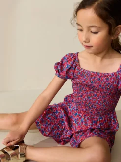 Jumpsuits En Playsuits*Next Roze met vrolijke print - Romper met smokwerk (3-16jr)