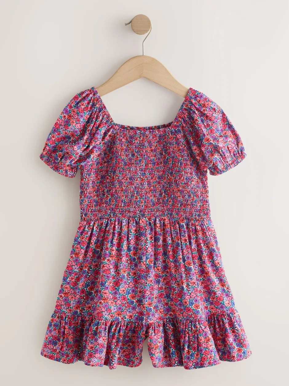 Jumpsuits En Playsuits*Next Roze met vrolijke print - Romper met smokwerk (3-16jr)