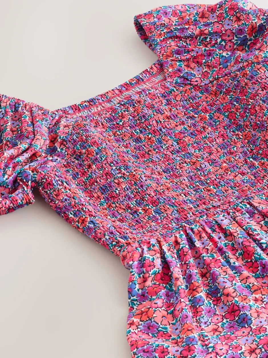 Jumpsuits En Playsuits*Next Roze met vrolijke print - Romper met smokwerk (3-16jr)