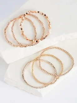 Sieraden|Next - Set van glinsterende rekbare armbanden Rozegouden tinten