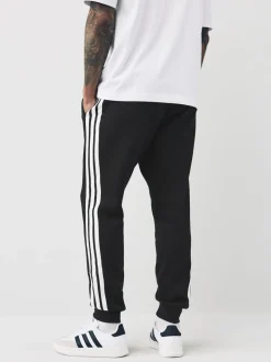 Joggingbroeken*adidas - Essentials fleece joggingbroek met 3 strepen Zwart