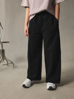 Broeken En Leggings*Next - Joggingbroek met wijde pijpen (3-16jr) Zwart