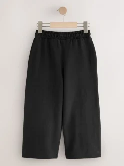 Broeken En Leggings*Next - Joggingbroek met wijde pijpen (3-16jr) Zwart