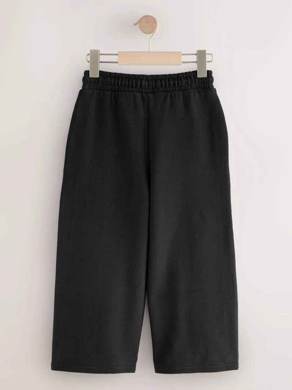 Broeken En Leggings*Next - Joggingbroek met wijde pijpen (3-16jr) Zwart