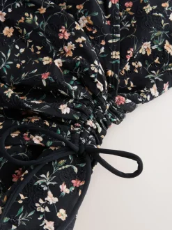 Badkleding|Next Zwart met broderie en fijne print - Badpak met vormgevende zijrimpeling en buikcorrectie
