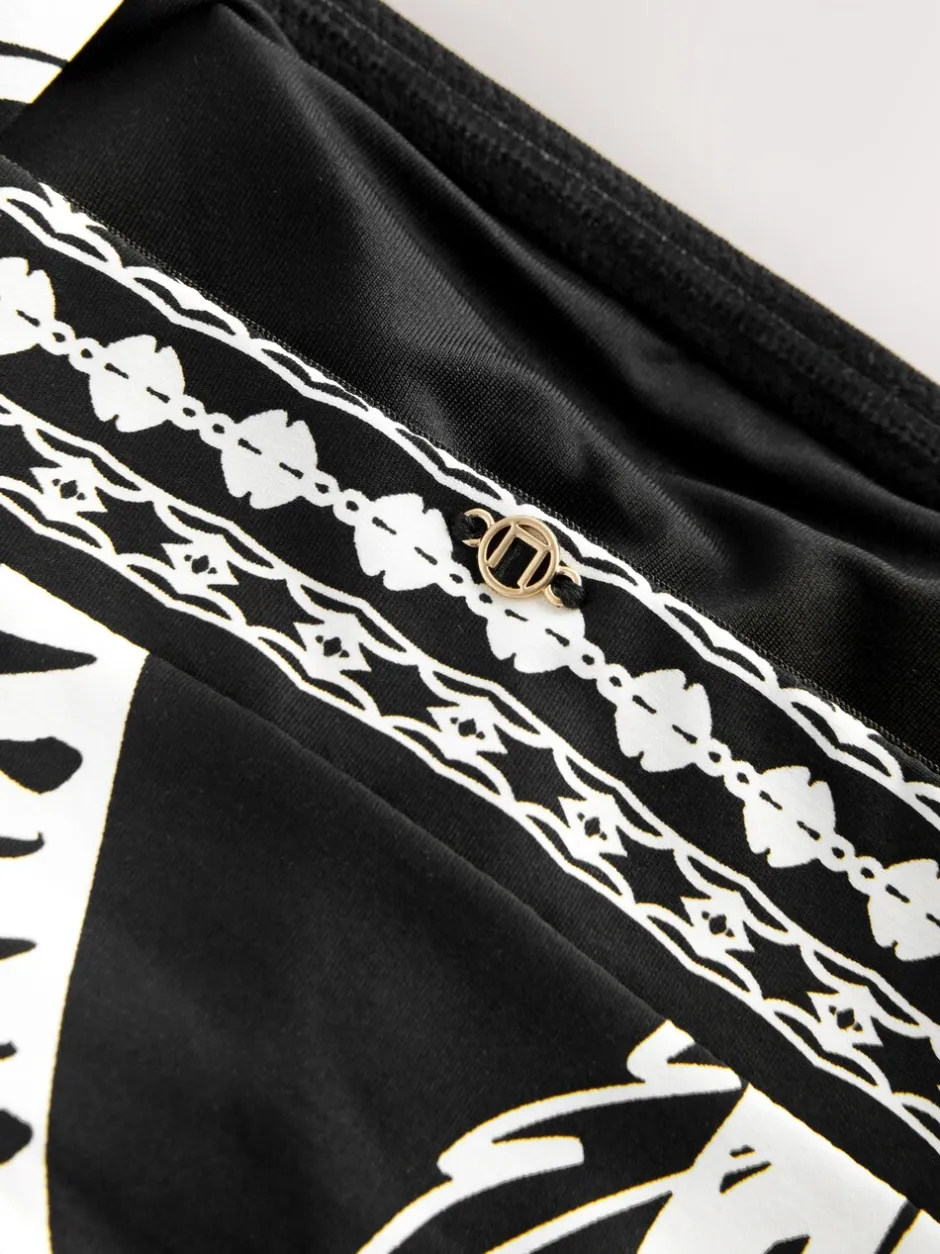Badkleding*Next Zwart/Crème Palm - Vormgevend bandeaubadpak met buikcorrectie en afgeronde pijpen
