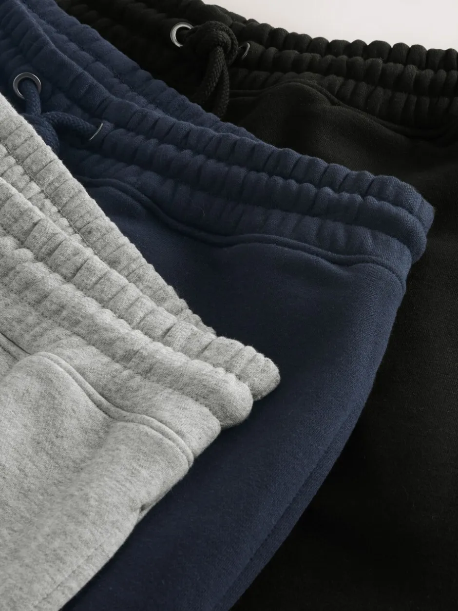 Joggingbroeken|Next - Verpakking van 3 slim-fit jersey joggingbroeken met hoog katoengehalte Zwart/marineblauw/grijs
